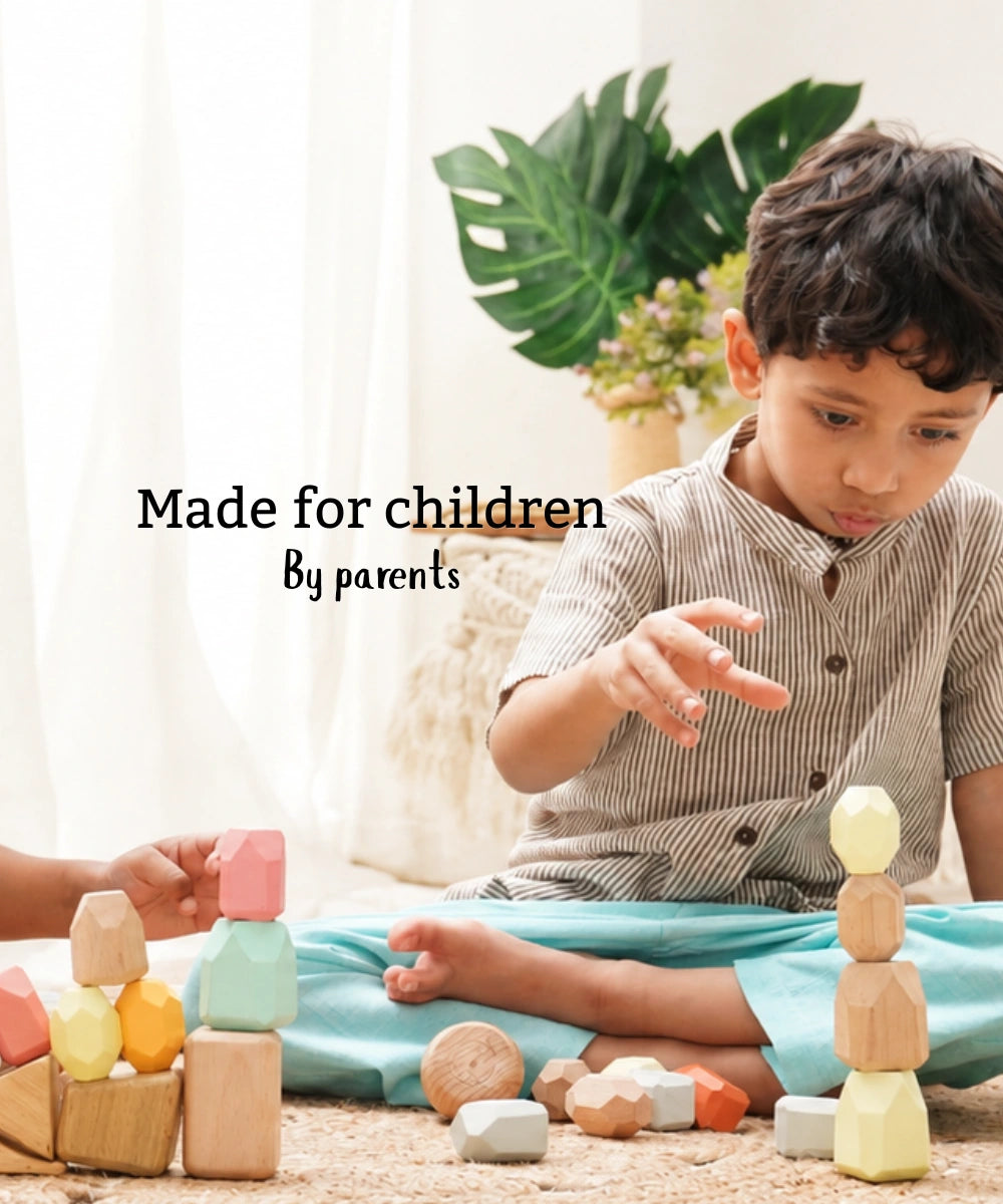 Boy building with wooden stacking toys on a jute rug, with the text made for children by parents