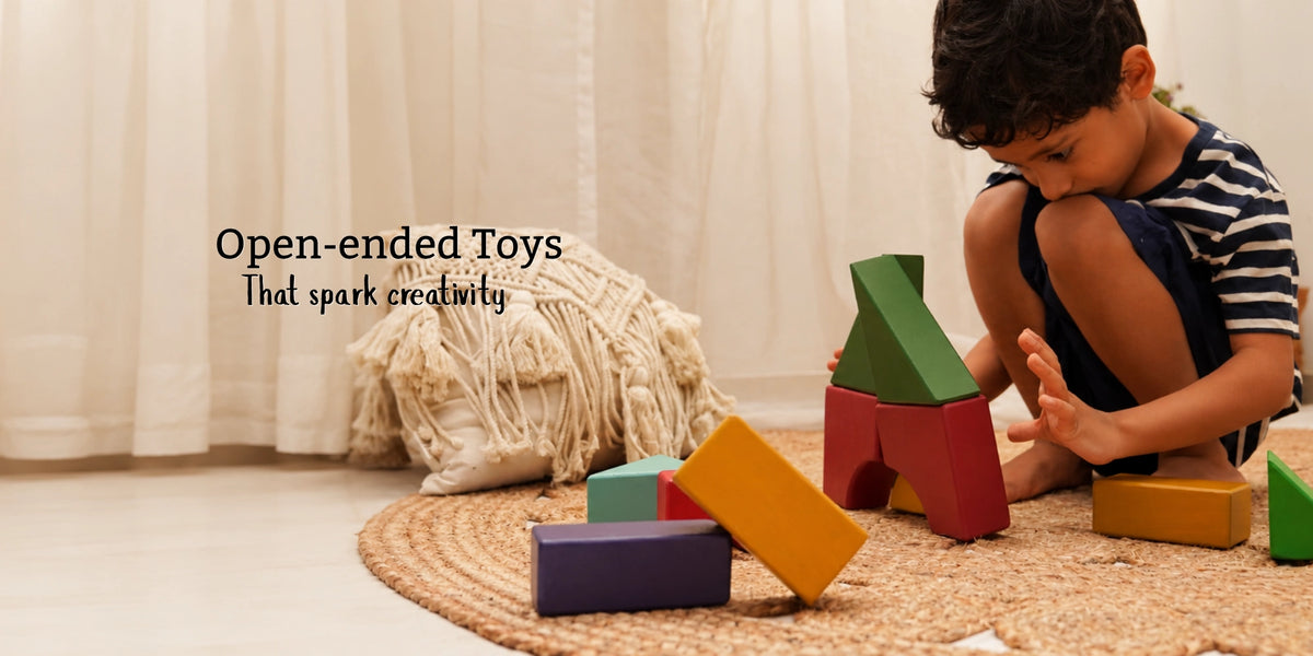 Boy playing with wooden building blocks on a jute rug in a sunlit room, with the text open-ended toys that spark creativity