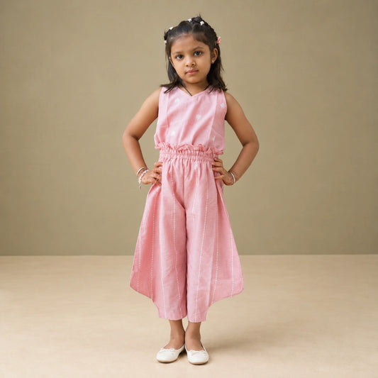 girl wearing pink coord set against a plain beige background