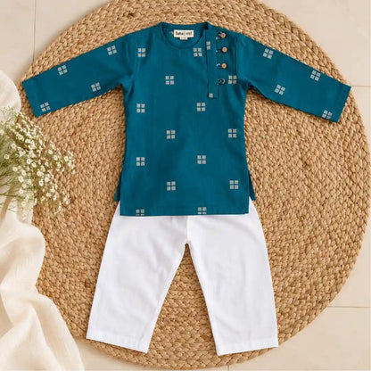 Flat lay of a teal full sleeve kurta with white woven square motifs and wooden buttons beside a white pajama