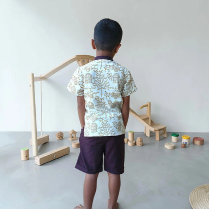 Back view of a handblock-printed Warli short kurta for children