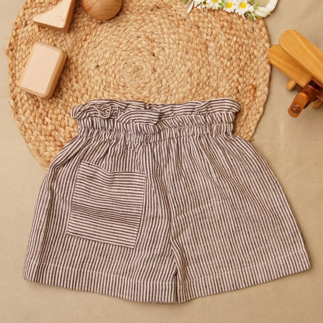 Striped shorts with a pocket on a woven mat background